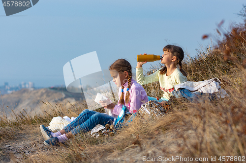 Image of Girls on a rest on a halt and drink water