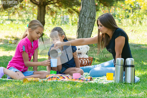 Image of Family tea party on a lawn picnic