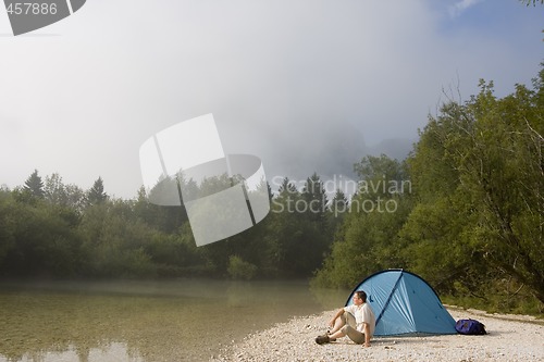 Image of Man sitting beside his tent