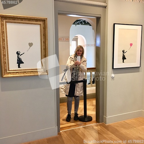 Image of Tourist woman is taking picture in Moco Museum, Amsterdam