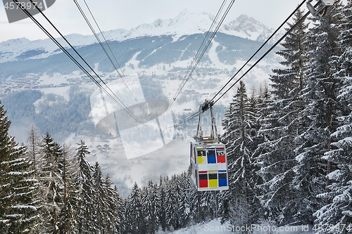 Image of Skiing lift cabin over a valley