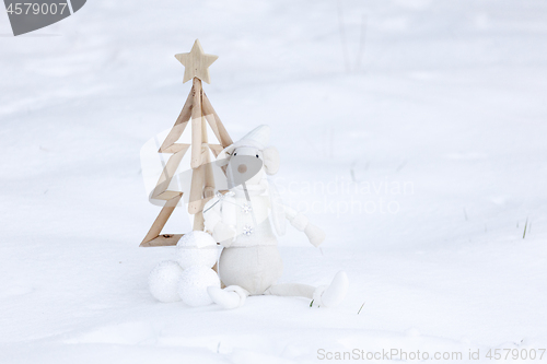 Image of Simple Christmas tree, baubles and decoration in fresh snow