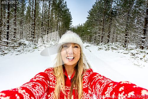 Image of Happy woman enjoying outdoors in the snow