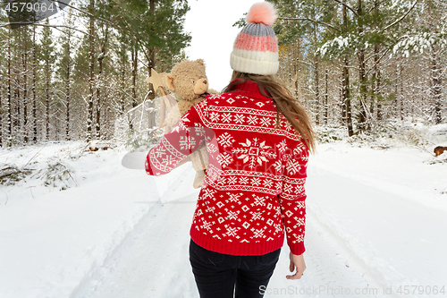 Image of Woman in snow covered forest in winter