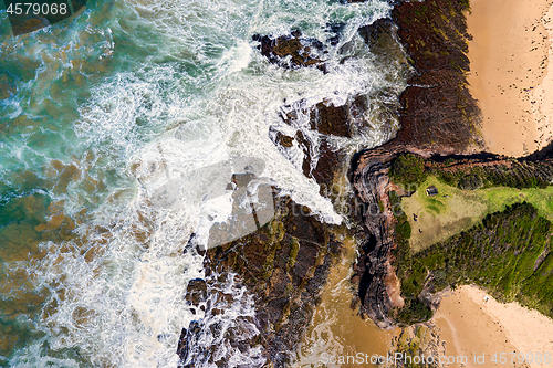 Image of Views over the steep headland to the rocky shores and beach below