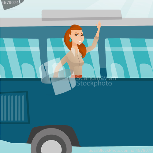 Image of Young caucasian woman waving hand from bus window.