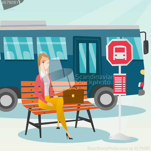 Image of Caucasian woman waiting for a bus at the bus stop.