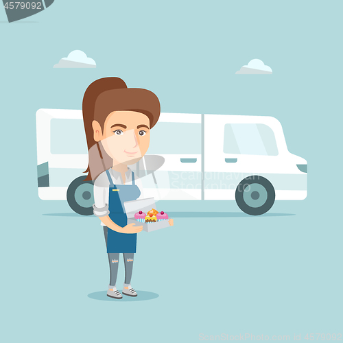 Image of Young caucasian baker delivering cakes.