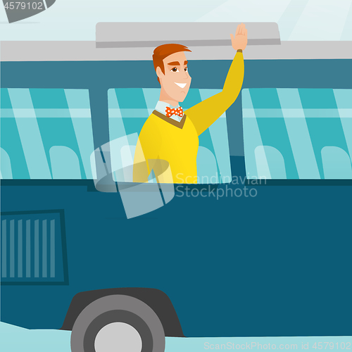 Image of Young caucasian man waving hand from bus window.