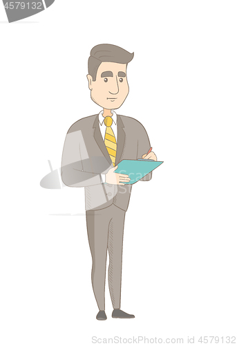 Image of Young caucasian businessman writing on clipboard.