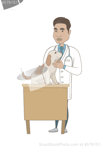 Image of Young hispanic veterinarian examining dog.