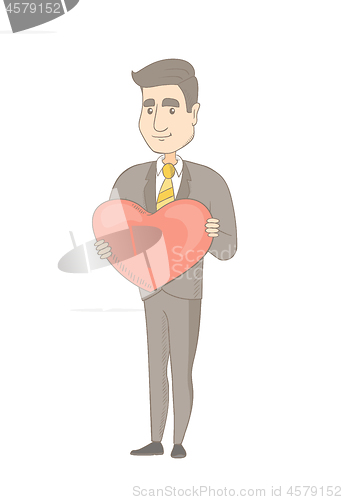 Image of Caucasian businessman holding a big red heart.