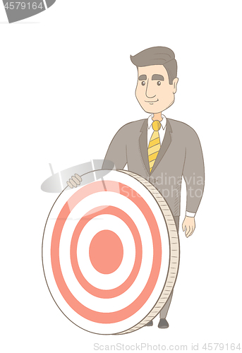 Image of Young caucasian businessman and dart board.