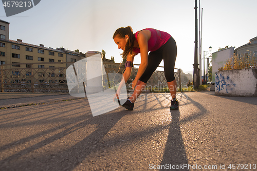 Image of athlete woman warming up and stretching