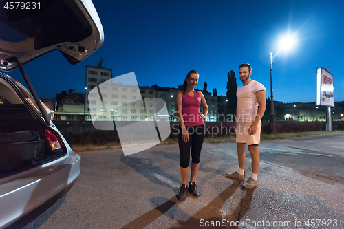 Image of couple warming up and stretching