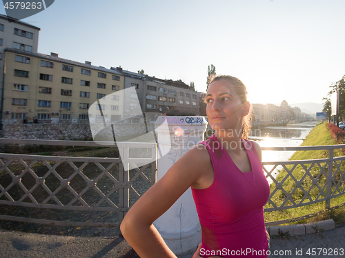 Image of portrait of a jogging woman at sunny morning