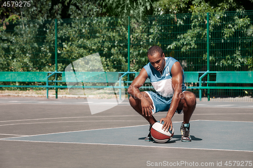 Image of Picture of young resting african basketball player