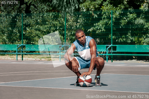 Image of Picture of young resting african basketball player