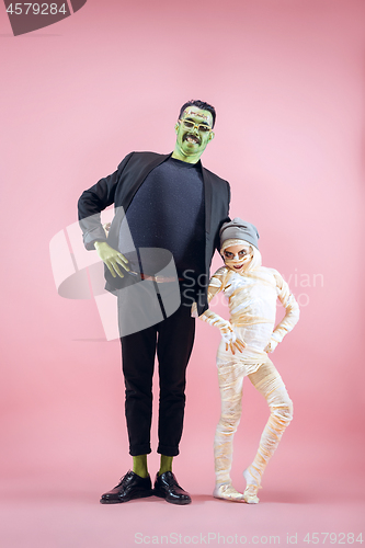 Image of Halloween Family. Happy Father and Children Girl in Halloween Costume and Makeup