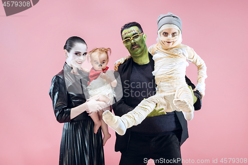 Image of Halloween Family. Happy Father, Mother and Children Girls in Halloween Costume and Makeup