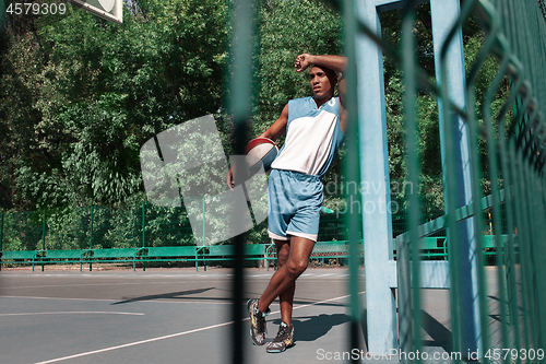 Image of Picture of young resting african basketball player