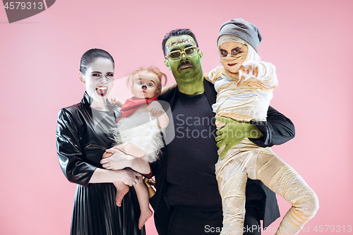 Image of Halloween Family. Happy Father, Mother and Children Girls in Halloween Costume and Makeup