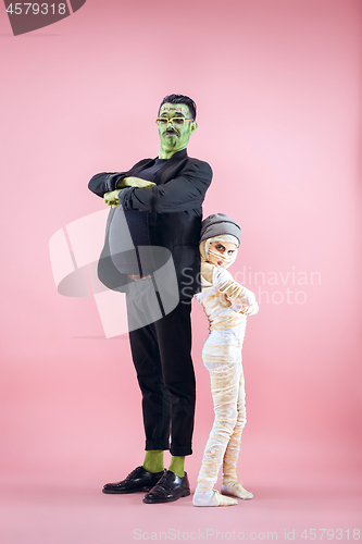 Image of Halloween Family. Happy Father and Children Girl in Halloween Costume and Makeup