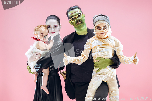 Image of Halloween Family. Happy Father, Mother and Children Girls in Halloween Costume and Makeup