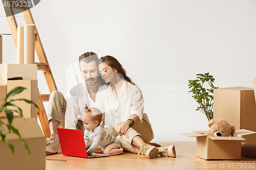 Image of Couple moving to a new home - Happy married people buy a new apartment to start new life together