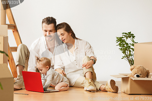 Image of Couple moving to a new home - Happy married people buy a new apartment to start new life together