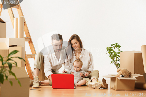 Image of Couple moving to a new home - Happy married people buy a new apartment to start new life together