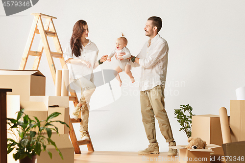 Image of Couple moving to a new home - Happy married people buy a new apartment to start new life together