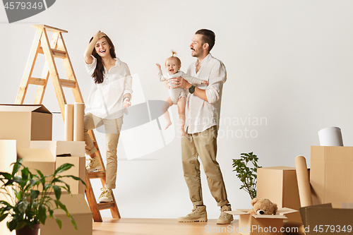 Image of Couple moving to a new home - Happy married people buy a new apartment to start new life together