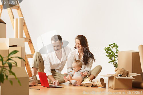 Image of Couple moving to a new home - Happy married people buy a new apartment to start new life together