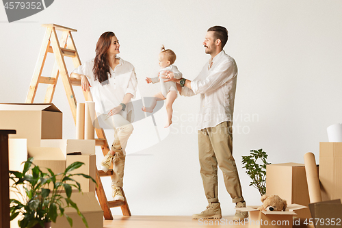 Image of Couple moving to a new home - Happy married people buy a new apartment to start new life together