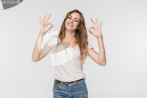 Image of The happy business woman standing and smiling against white background.