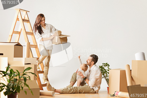 Image of Couple moving to a new home - Happy married people buy a new apartment to start new life together