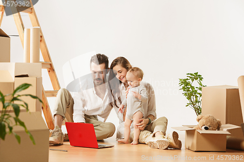 Image of Couple moving to a new home - Happy married people buy a new apartment to start new life together