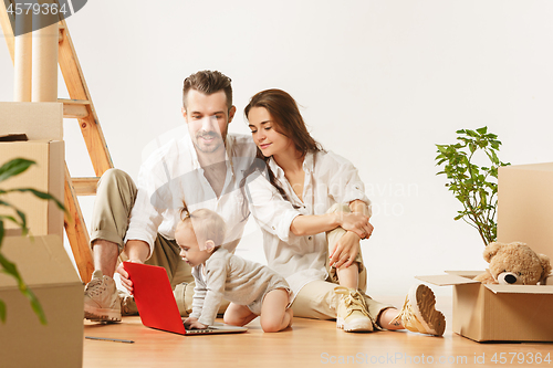 Image of Couple moving to a new home - Happy married people buy a new apartment to start new life together