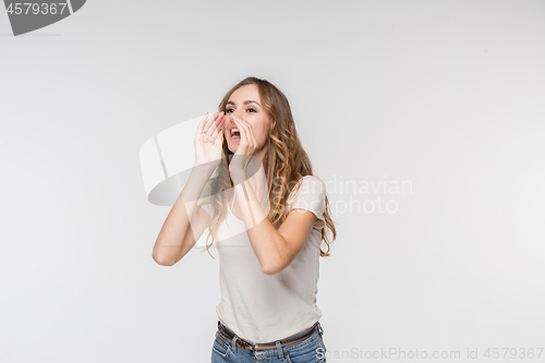 Image of Isolated on pink young casual woman shouting at studio