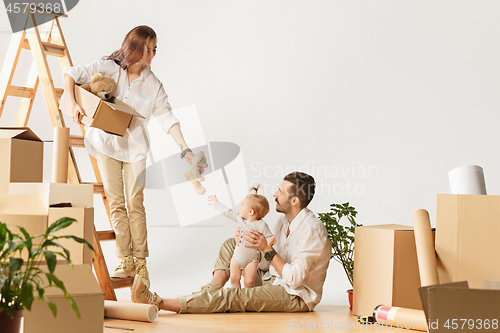 Image of Couple moving to a new home - Happy married people buy a new apartment to start new life together