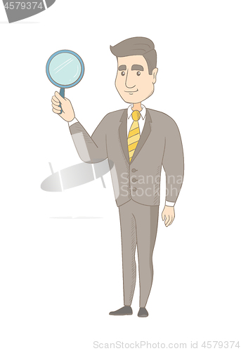 Image of Young caucasian businessman with magnifying glass.