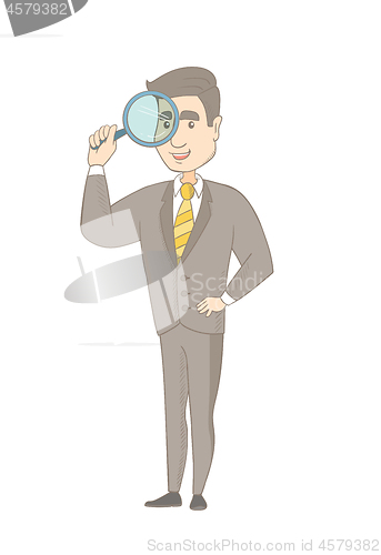 Image of Young caucasian businessman with magnifying glass.