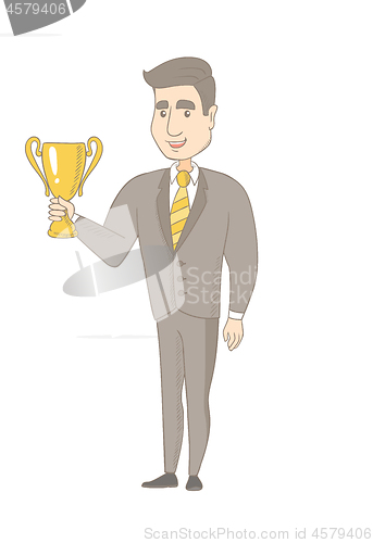 Image of Young caucasian businessman holding a trophy.