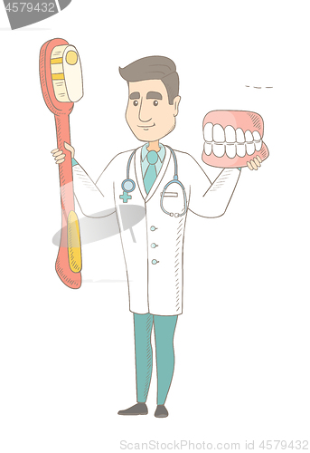 Image of Dentist with dental jaw model and toothbrush.