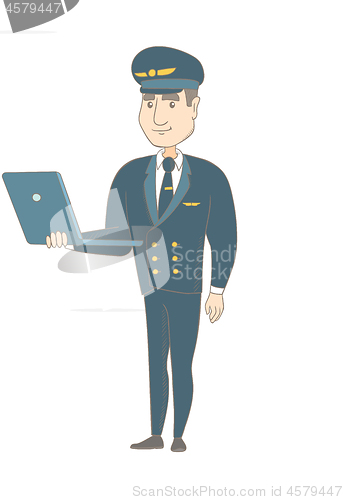 Image of Young caucasian pilot using a laptop.