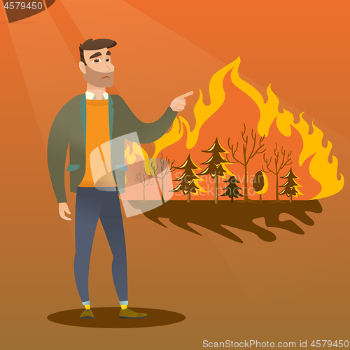 Image of Man standing on the background of wildfire.