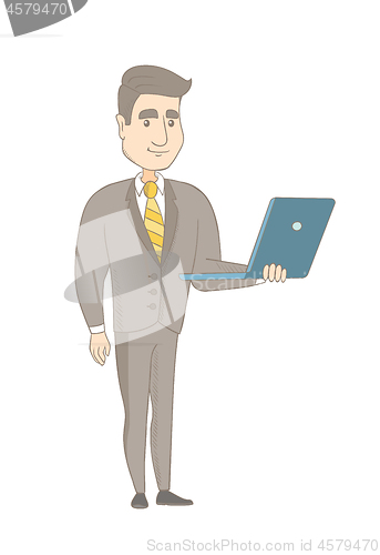 Image of Young caucasian businessman using a laptop.