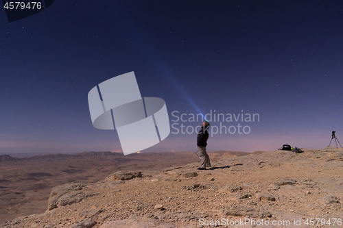 Image of Light beam into the night desert