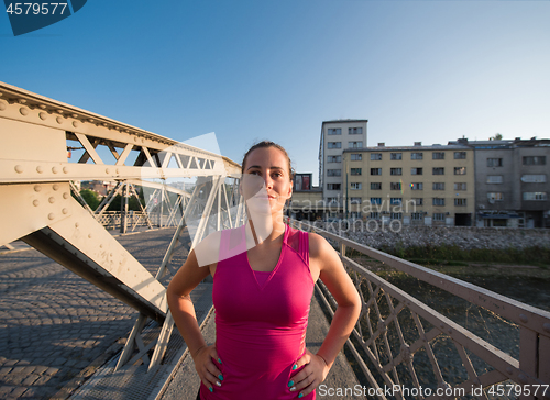 Image of portrait of a jogging woman at sunny morning